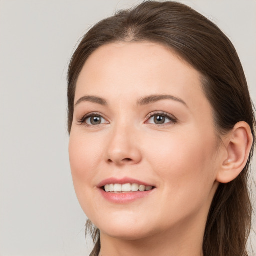 Joyful white young-adult female with long  brown hair and grey eyes