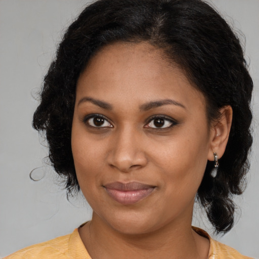 Joyful black young-adult female with medium  brown hair and brown eyes