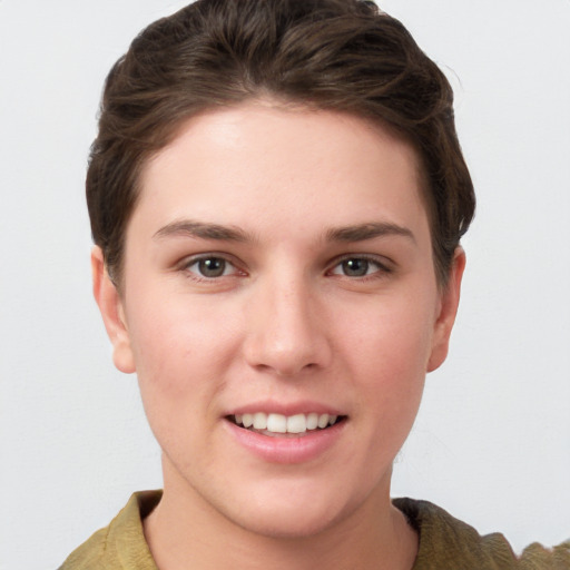 Joyful white young-adult female with short  brown hair and grey eyes