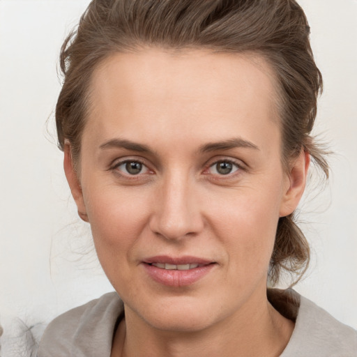 Joyful white adult female with medium  brown hair and grey eyes