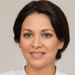 Joyful white adult female with medium  brown hair and brown eyes