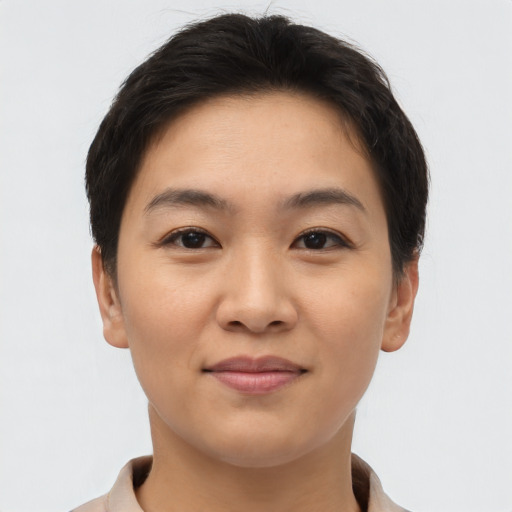 Joyful asian young-adult female with short  brown hair and brown eyes