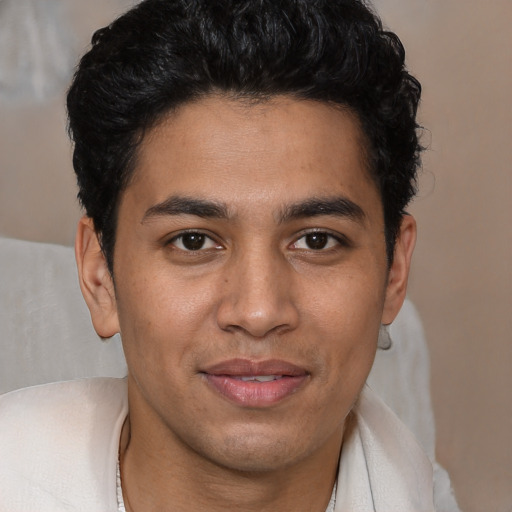 Joyful latino young-adult male with short  black hair and brown eyes