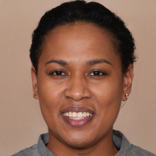 Joyful latino young-adult female with short  black hair and brown eyes