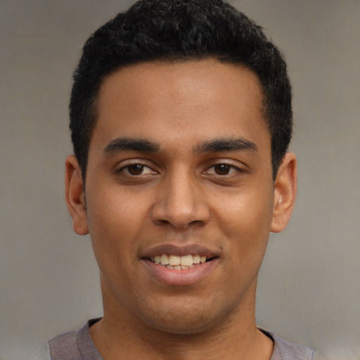 Joyful latino young-adult male with short  black hair and brown eyes