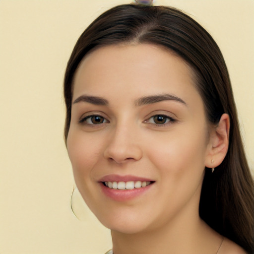 Joyful white young-adult female with long  black hair and brown eyes