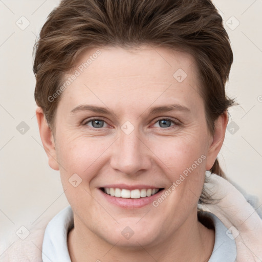 Joyful white young-adult female with short  brown hair and grey eyes