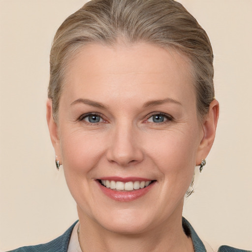 Joyful white adult female with medium  brown hair and blue eyes