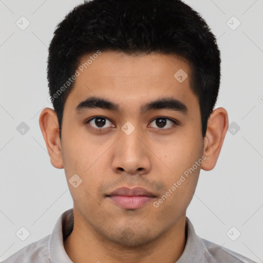 Neutral latino young-adult male with short  black hair and brown eyes