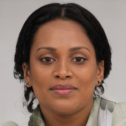 Joyful black young-adult female with medium  brown hair and brown eyes