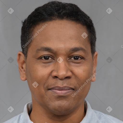 Joyful latino adult male with short  brown hair and brown eyes