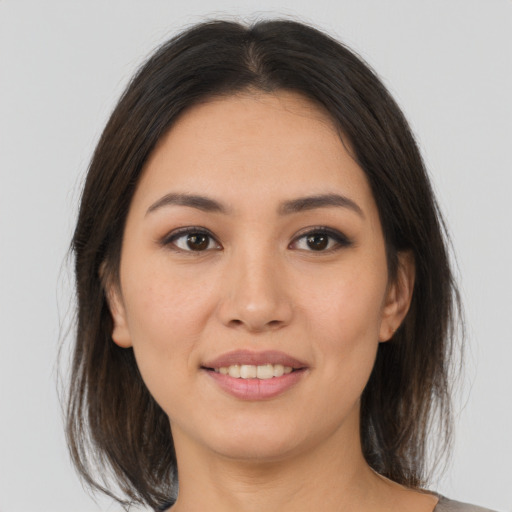 Joyful asian young-adult female with medium  brown hair and brown eyes