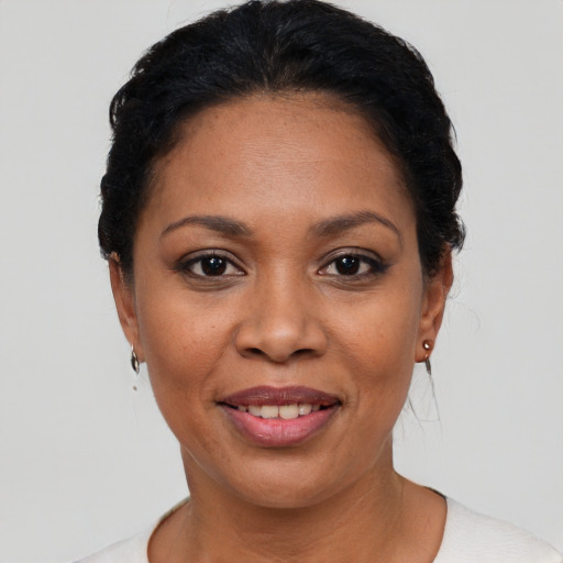 Joyful latino adult female with short  black hair and brown eyes