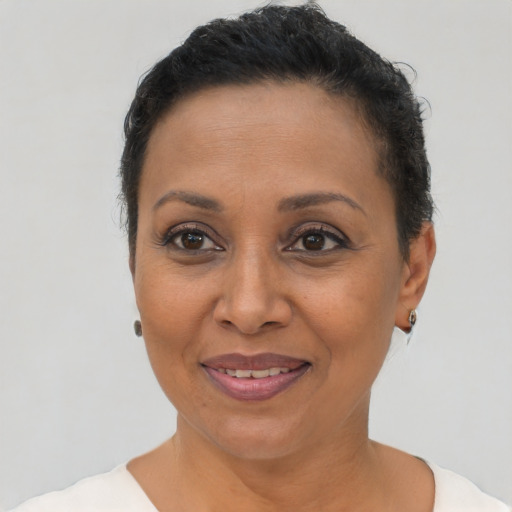 Joyful latino adult female with short  brown hair and brown eyes