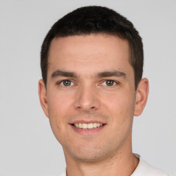 Joyful white young-adult male with short  brown hair and brown eyes