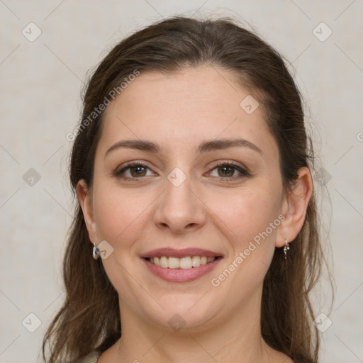 Joyful white young-adult female with long  brown hair and grey eyes