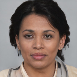 Joyful asian adult female with medium  brown hair and brown eyes