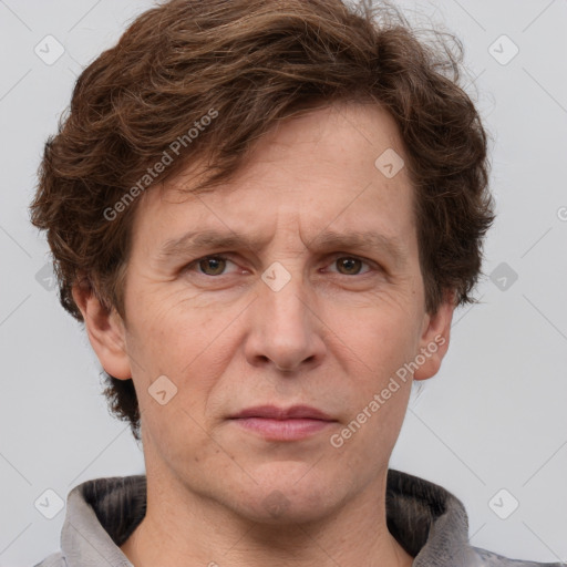 Joyful white adult male with short  brown hair and grey eyes