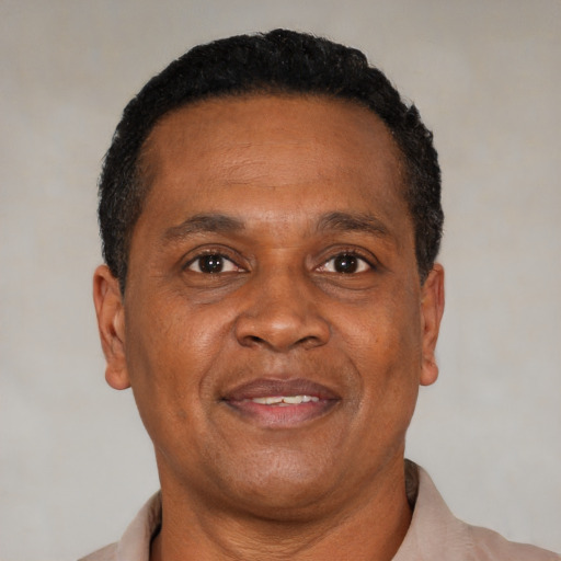 Joyful latino adult male with short  brown hair and brown eyes