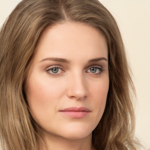 Joyful white young-adult female with long  brown hair and green eyes