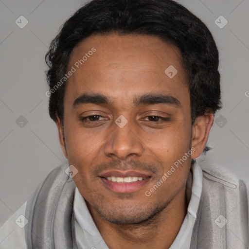 Joyful white young-adult male with short  black hair and brown eyes