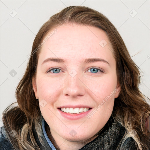 Joyful white young-adult female with long  brown hair and blue eyes