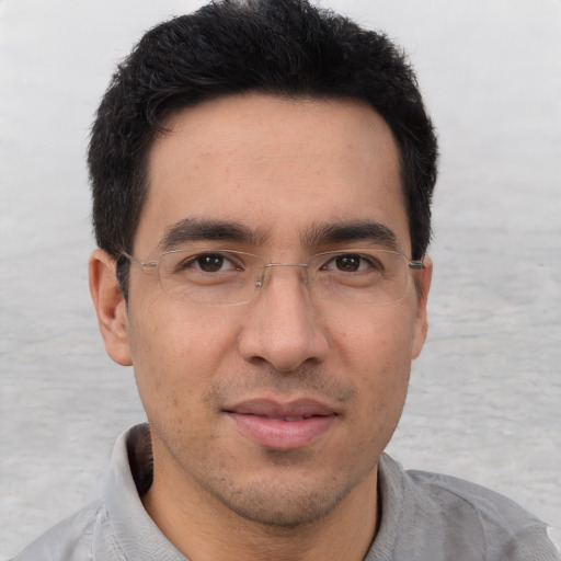 Joyful asian young-adult male with short  brown hair and brown eyes