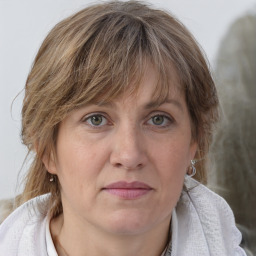 Joyful white adult female with medium  brown hair and blue eyes