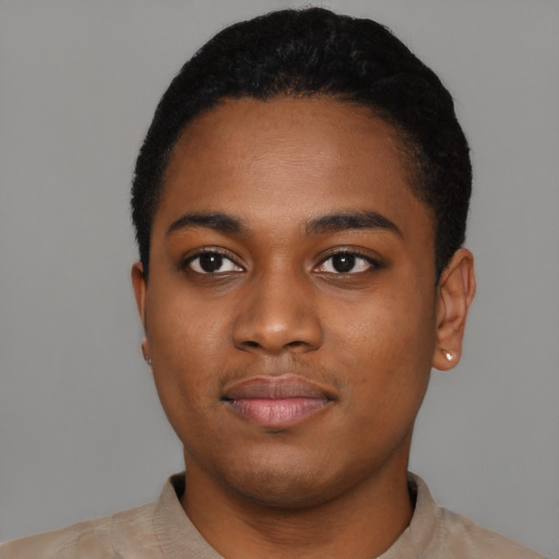 Joyful black young-adult female with short  black hair and brown eyes