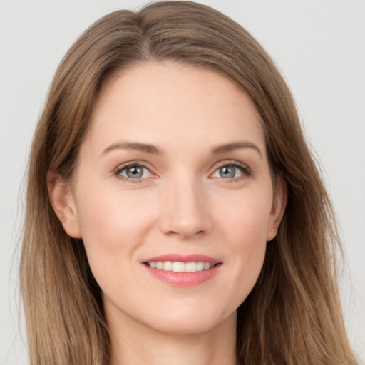 Joyful white young-adult female with long  brown hair and grey eyes