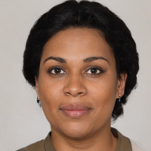 Joyful black young-adult female with medium  brown hair and brown eyes