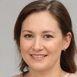 Joyful white adult female with medium  brown hair and brown eyes