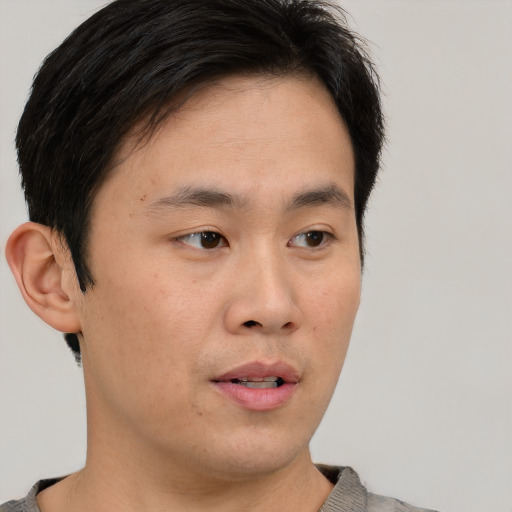 Neutral asian young-adult male with short  brown hair and brown eyes