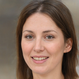 Joyful white adult female with long  brown hair and brown eyes