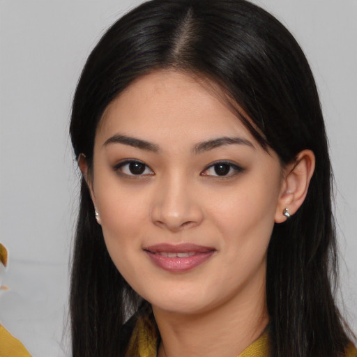 Joyful asian young-adult female with long  black hair and brown eyes