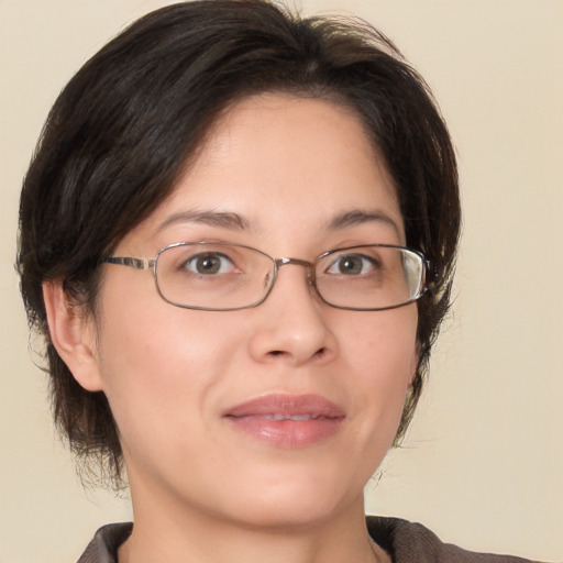 Joyful white adult female with medium  brown hair and brown eyes