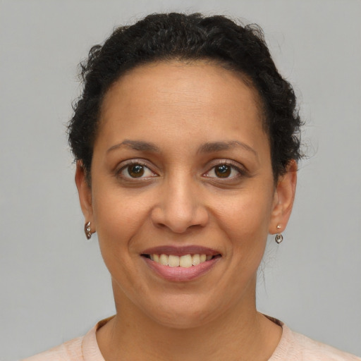 Joyful latino young-adult female with short  brown hair and brown eyes