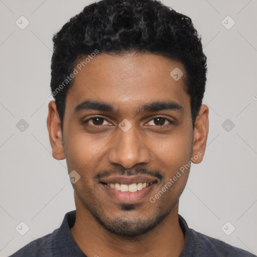 Joyful black young-adult male with short  black hair and brown eyes