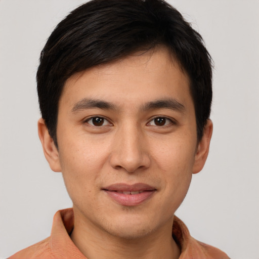 Joyful asian young-adult male with short  brown hair and brown eyes