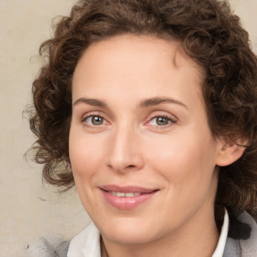 Joyful white young-adult female with medium  brown hair and green eyes