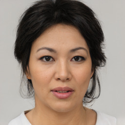 Joyful asian adult female with medium  brown hair and brown eyes