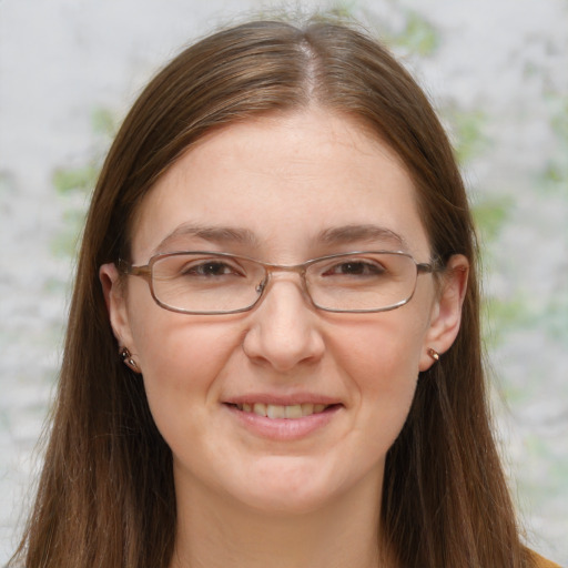 Joyful white adult female with long  brown hair and grey eyes