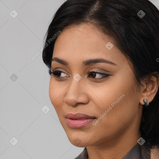 Joyful latino young-adult female with long  black hair and brown eyes