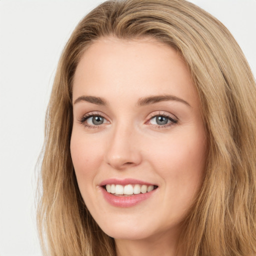 Joyful white young-adult female with long  brown hair and green eyes