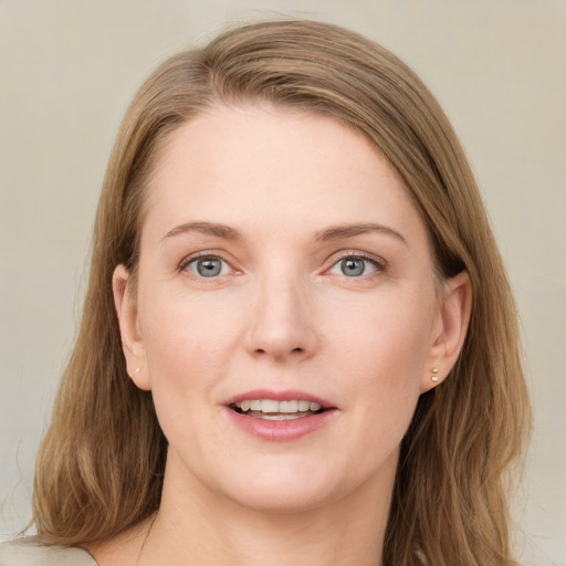 Joyful white young-adult female with medium  brown hair and grey eyes