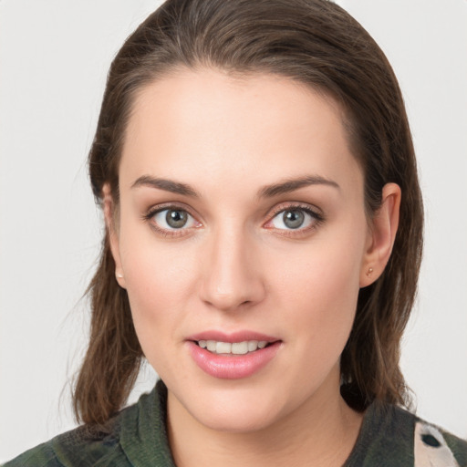 Joyful white young-adult female with medium  brown hair and green eyes