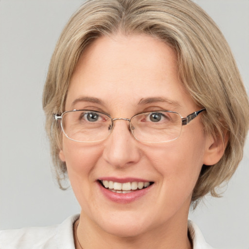 Joyful white adult female with medium  brown hair and blue eyes