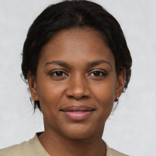 Joyful black young-adult female with medium  brown hair and brown eyes