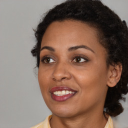 Joyful black young-adult female with medium  brown hair and brown eyes