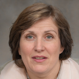 Joyful white adult female with medium  brown hair and blue eyes